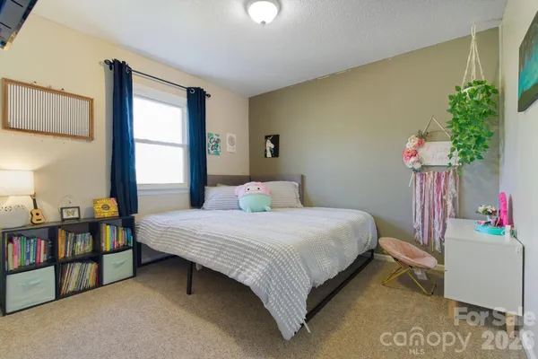 a bedroom with a bed and a potted plant