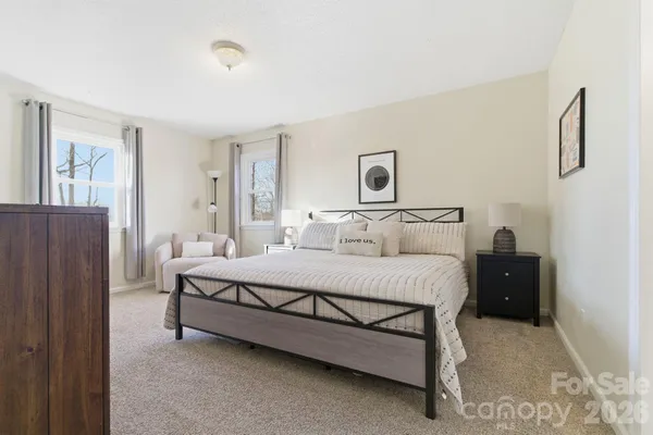 a bedroom with a bed lamp and a window