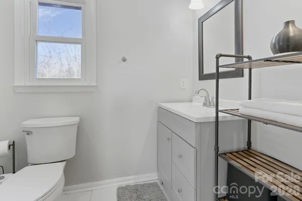 a bathroom with a sink toilet and mirror