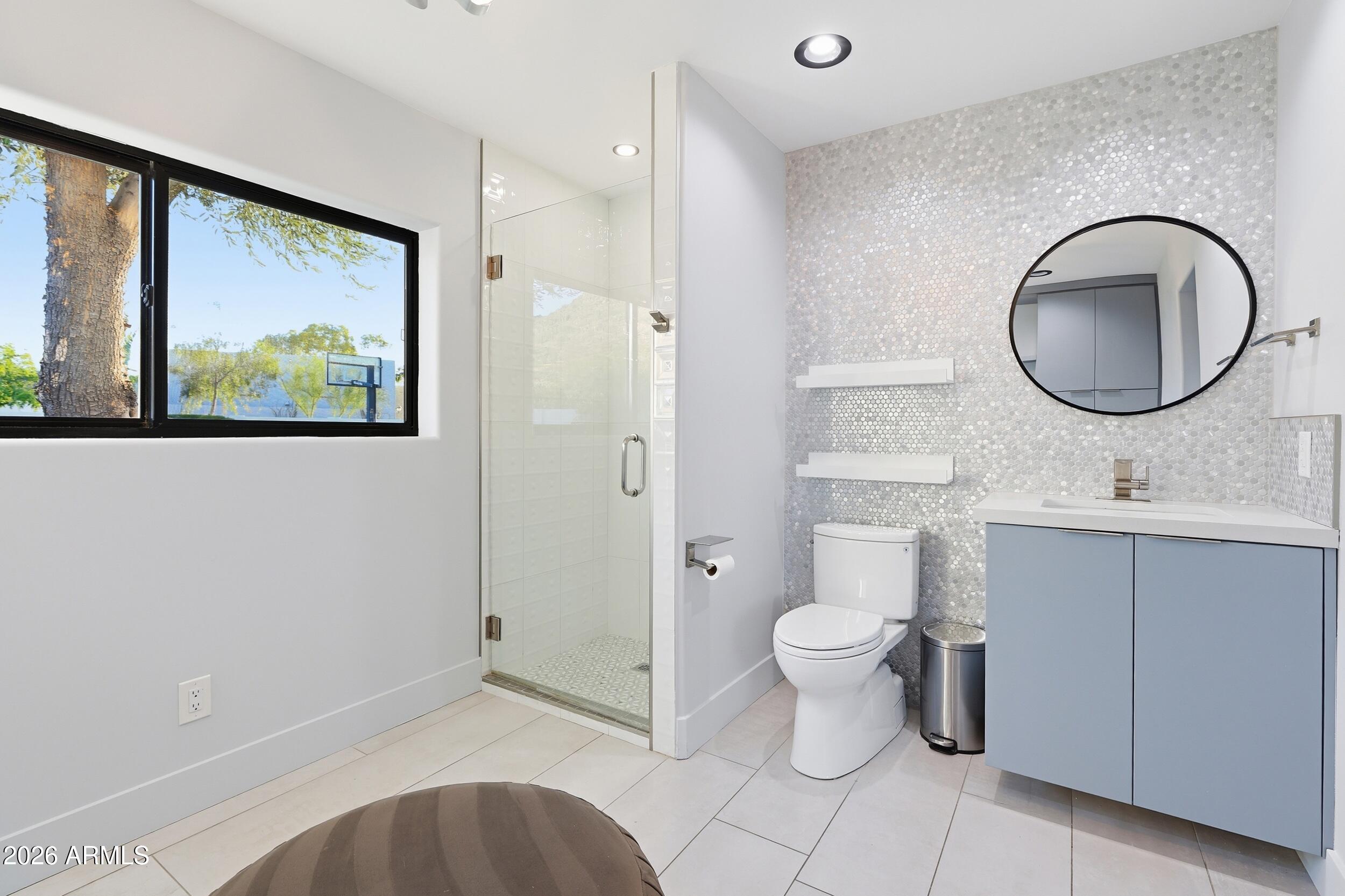 4417 East Mountain View Road Phoenix, AZ 85028 - Photo 27 of 41 a bathroom with a toilet a sink and a mirror