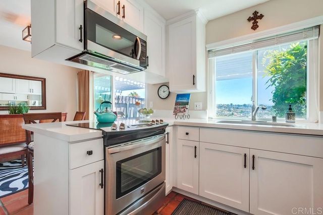 a kitchen with stainless steel appliances a stove sink and cabinets