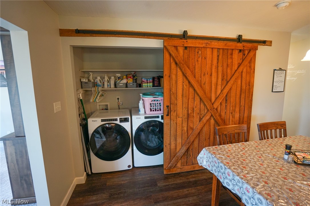 1325 County Line Road Hopewell, OH 43746 - Photo 7 of 45 Laundry area featuring dark wood-style flooring, washing machine and clothes dryer, and a barn door