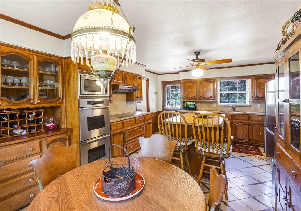 216 McMillen Road Lucas, TX 75002 - Photo 10 of 36 a dining room with furniture a chandelier and wooden floor