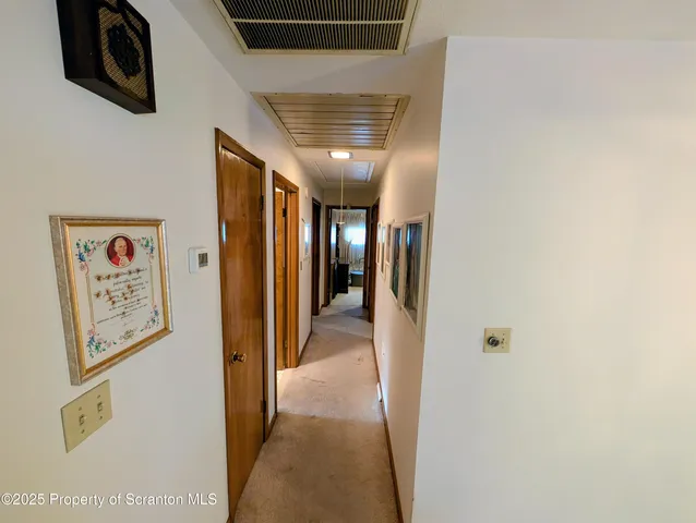 a view of a hallway with paintings on the wall