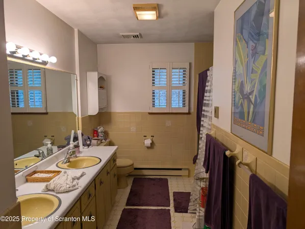 a bathroom with a granite countertop tub sink and mirror