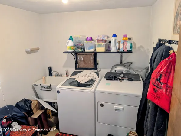 a view of storage and utility room with washer and dryer