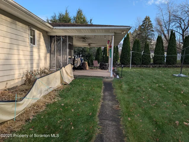 a view of a backyard with porch and patio