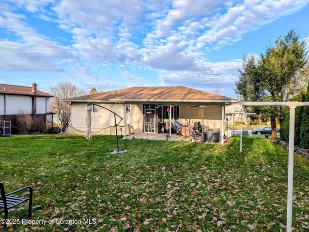 a view of a house with backyard and sitting area