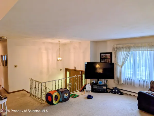 a living room with a flat screen tv and a window