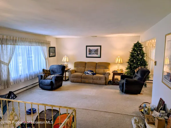a living room with furniture and a painting on the wall