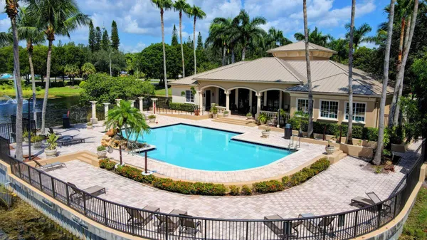 a view of a house with pool and sitting area