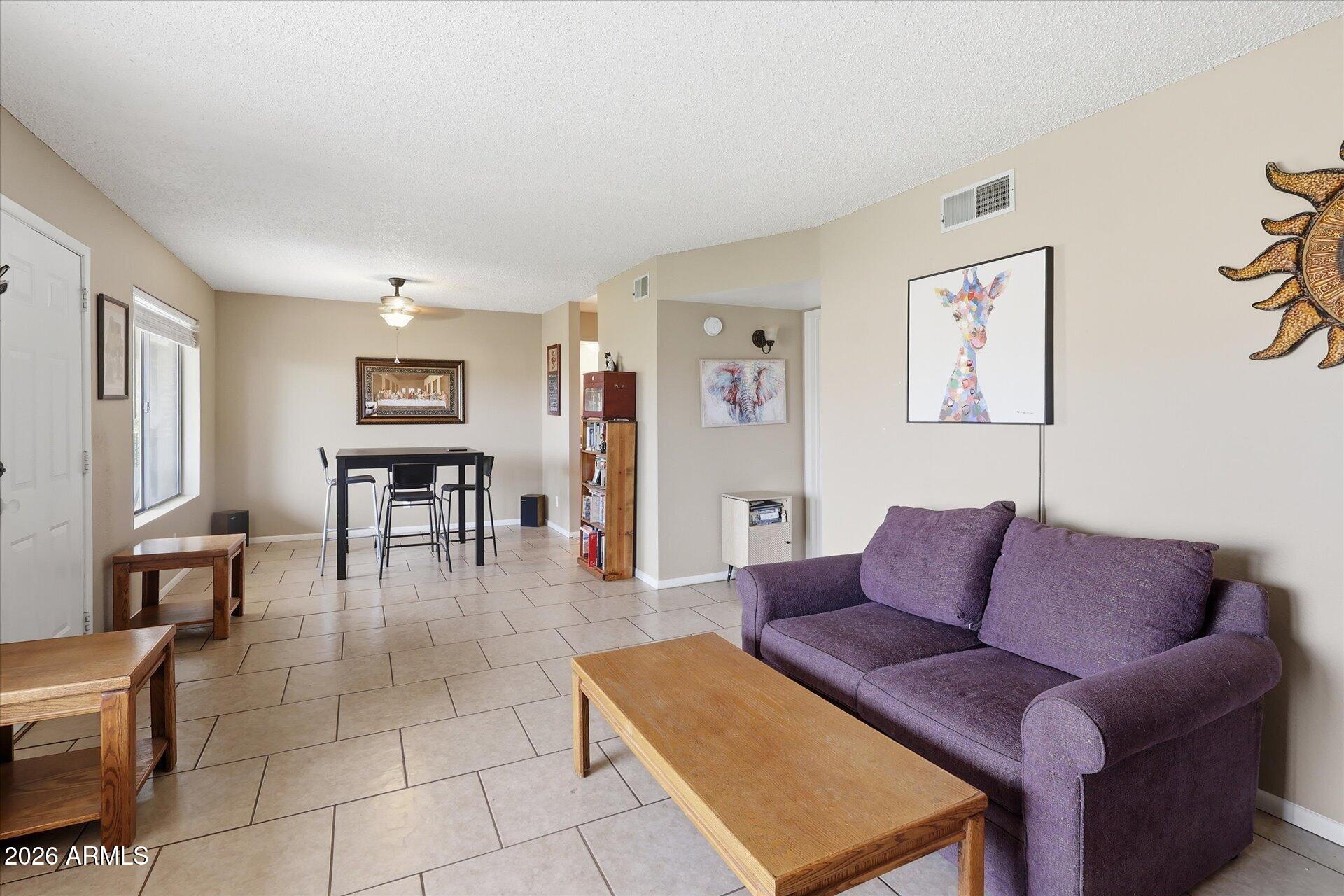 3270 South Goldfield Road, Unit 716 Apache Junction, AZ 85119 - Photo 12 of 36 a living room with furniture and a dining table