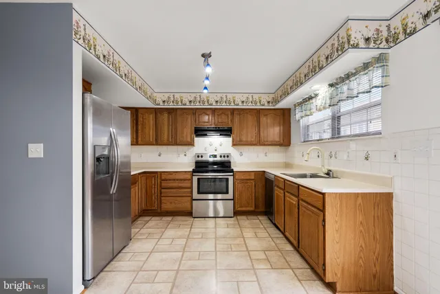 a kitchen with stainless steel appliances granite countertop a sink and cabinets