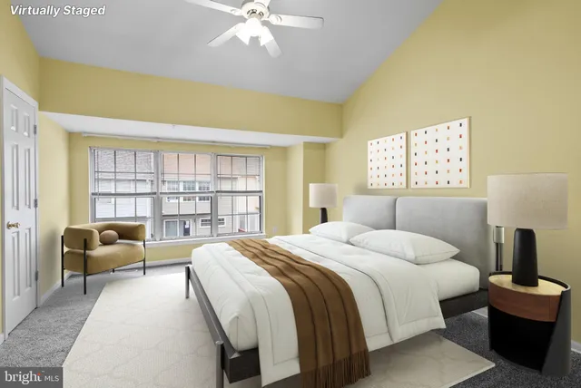 a bedroom with a large bed and a large window