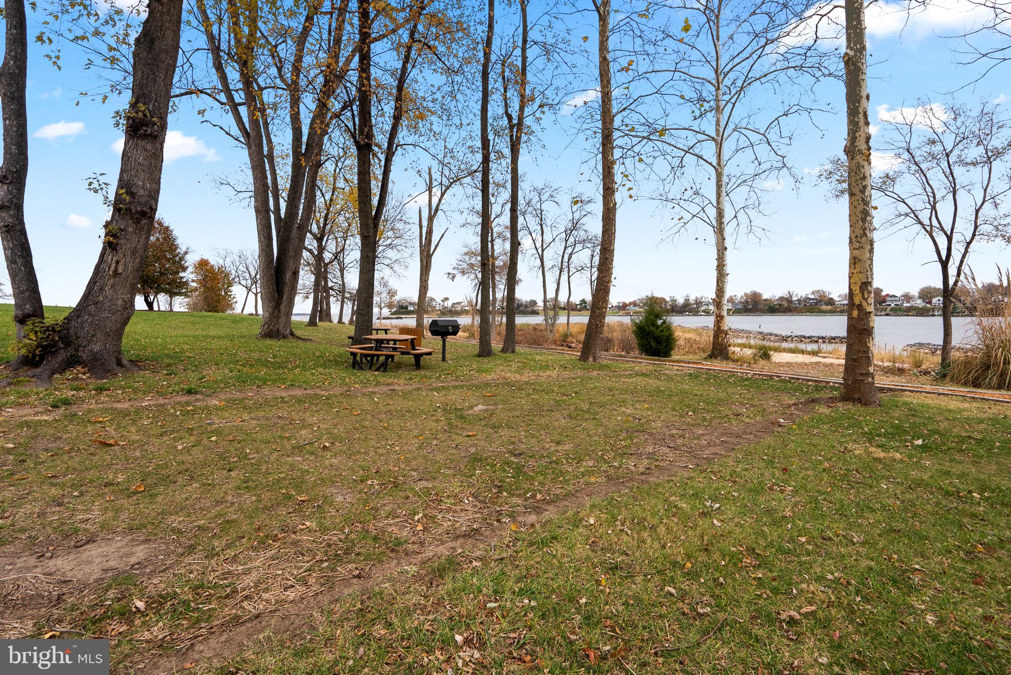 1346 Waterway Court, Unit 186 Curtis Bay, MD 21226 - Photo 37 of 44 a backyard of apartments with large trees