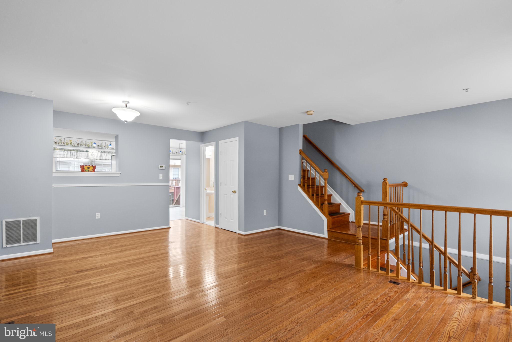 1346 Waterway Court, Unit 186 Curtis Bay, MD 21226 - Photo 7 of 44 a view of an empty room with wooden floor and a window