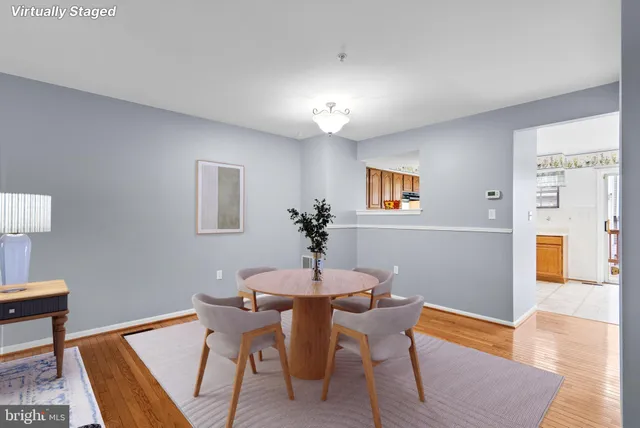 a dining room with furniture and wooden floor
