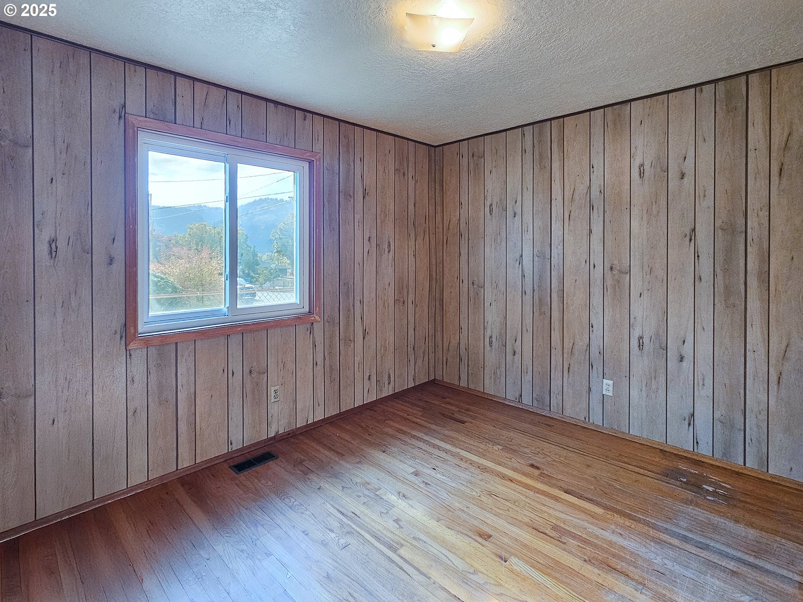 7750 North Decatur Street Portland, OR 97203 - Photo 16 of 28 an empty room with wooden floor and windows