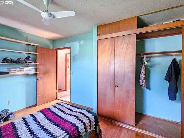 a bedroom with a bed and a mirror on the dresser