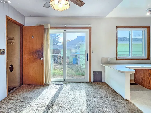 a view of an entryway with a chandelier fan