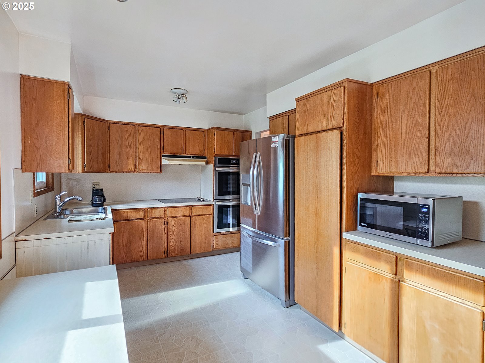 7750 North Decatur Street Portland, OR 97203 - Photo 8 of 28 a kitchen with stainless steel appliances granite countertop a refrigerator and a stove top oven
