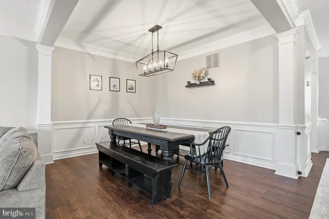 a dining room with a wooden table and chairs