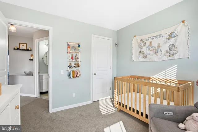 a bedroom with furniture and baby crib