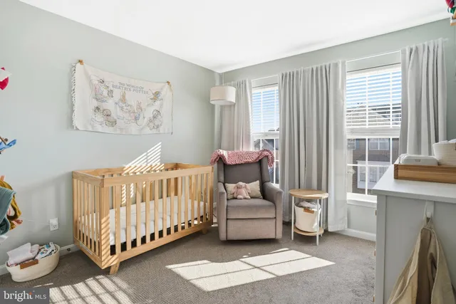 a bedroom with furniture and a large window