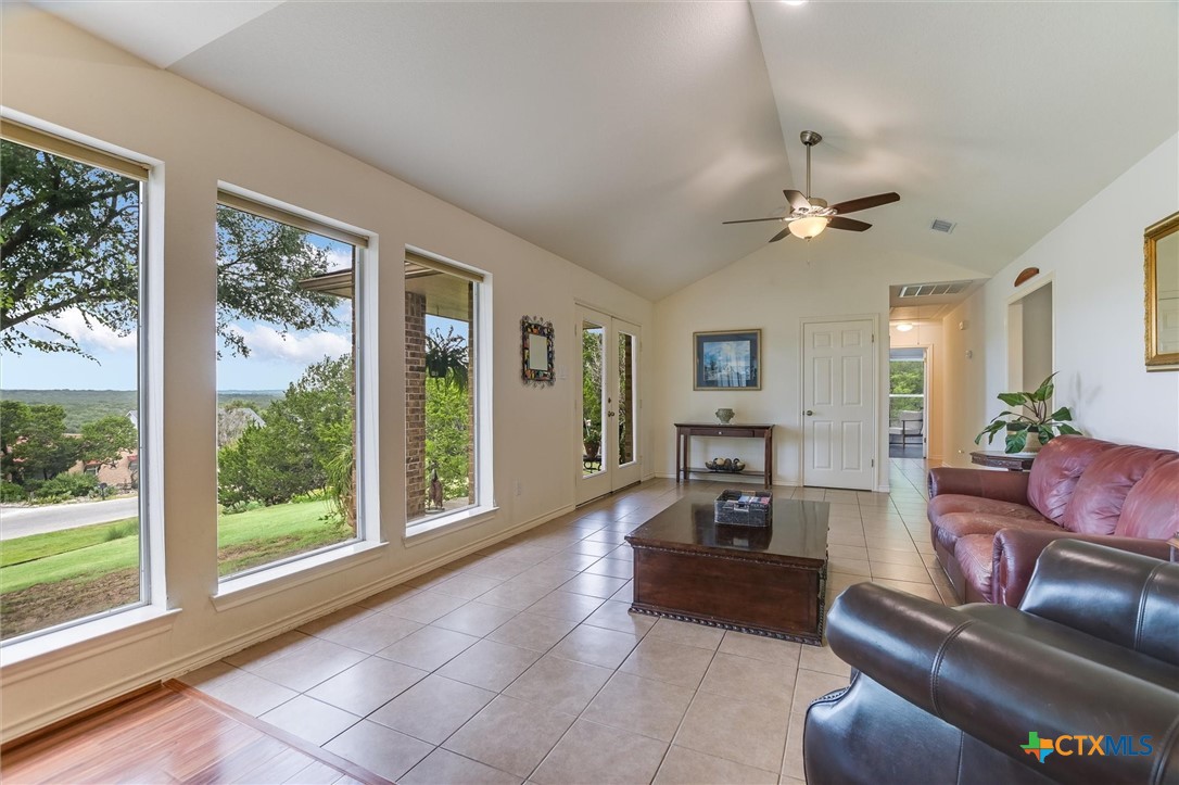 60 Crazy Cross Road Wimberley, TX 78676 - Photo 4 of 20 A spacious living area with soaring ceilings and expansive windows offers sweeping outdoor views.