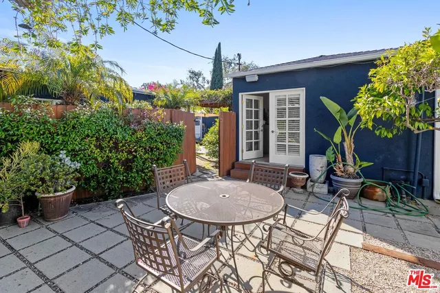 a view of a patio with a chairs and potted plants