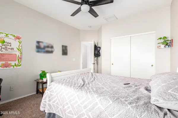 a bedroom with a bed and a chandelier