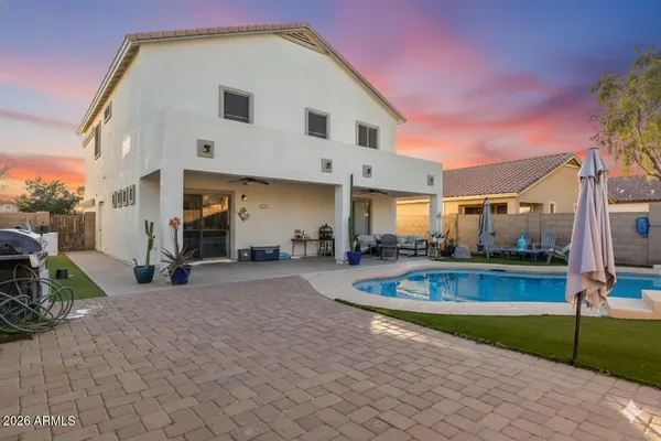 a view of a house with backyard and sitting area