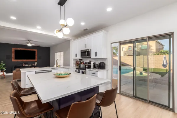 a kitchen with a dining table and chairs