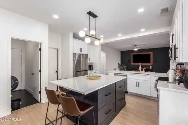a kitchen with a center island appliances and cabinets