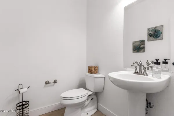 a bathroom with a sink a toilet and mirror