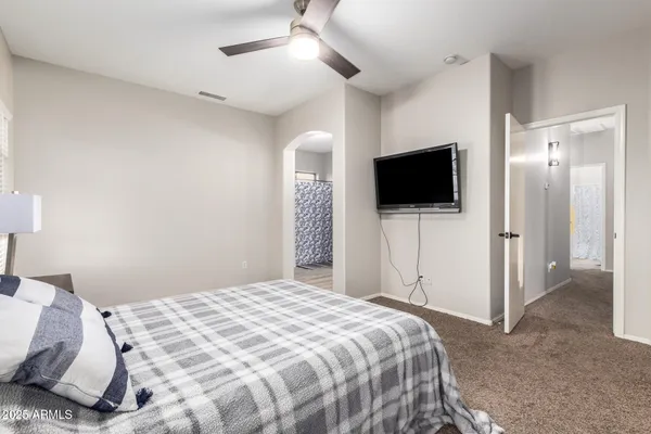 a bedroom with a bed and a flat screen tv