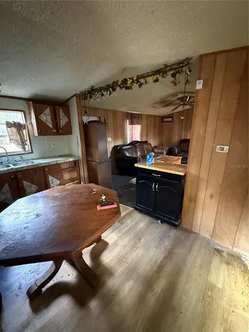 a kitchen with sink refrigerator and cabinets