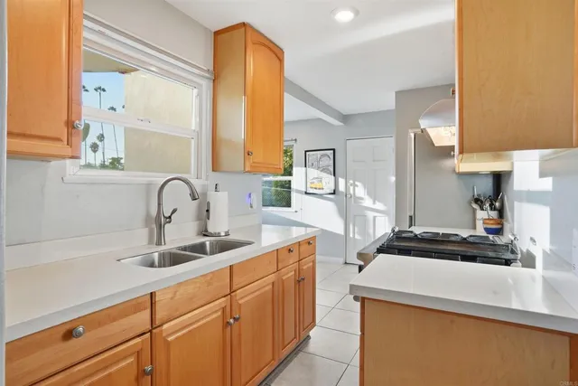 a kitchen with stainless steel appliances a sink a stove and a refrigerator