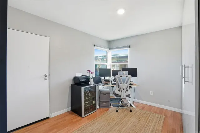a view of a workspace with furniture and wooden floor