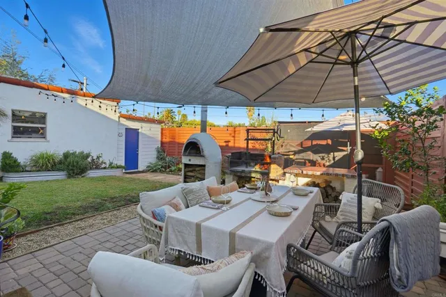 a view of backyard of house with seating space