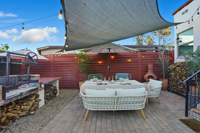 a roof deck with table and chairs