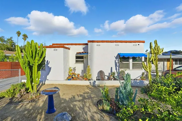 a view of palm trees and building in the background
