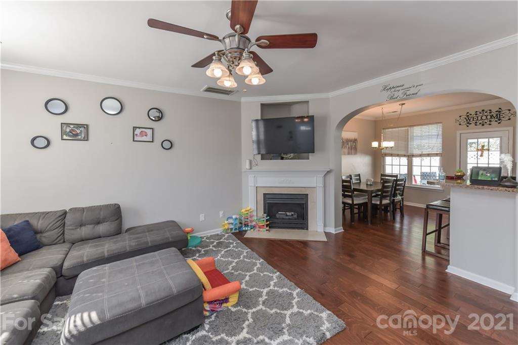 732 Shellstone Place, Unit 732 Fort Mill, SC 29708 - Photo 11 of 28 a living room with furniture a fireplace and a flat screen tv