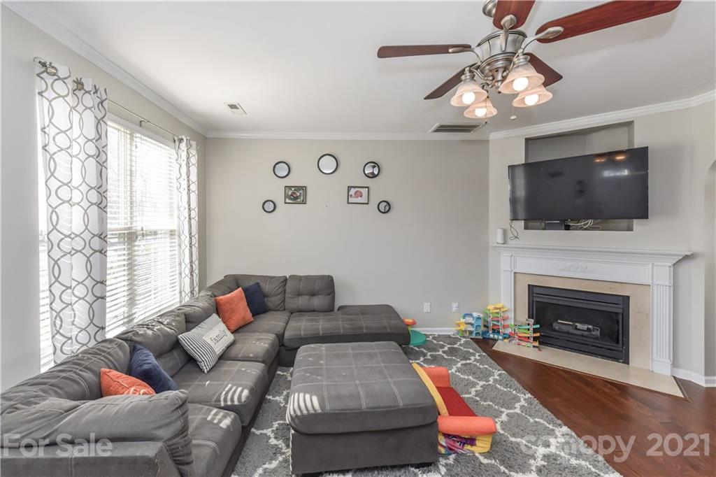 732 Shellstone Place, Unit 732 Fort Mill, SC 29708 - Photo 10 of 28 a living room with furniture a fireplace and a flat screen tv
