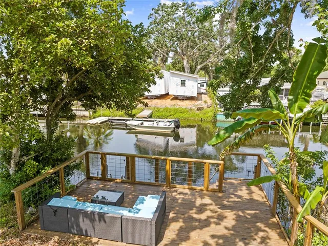 a view of a roof deck with wooden floor and fence