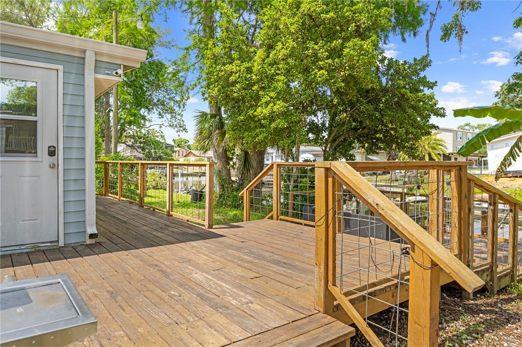 6380 Richard Drive Weeki Wachee, FL 34607 - Photo 21 of 59 a deck view with wooden floor and fence next to a yard