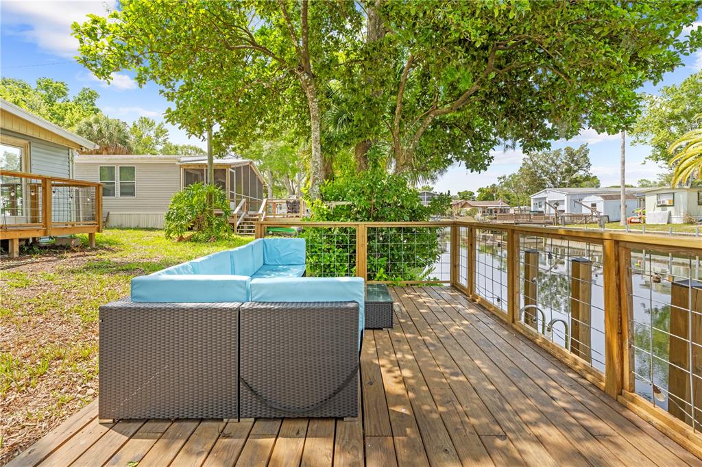 6380 Richard Drive Weeki Wachee, FL 34607 - Photo 23 of 59 a view of a roof deck with wooden floor and fence