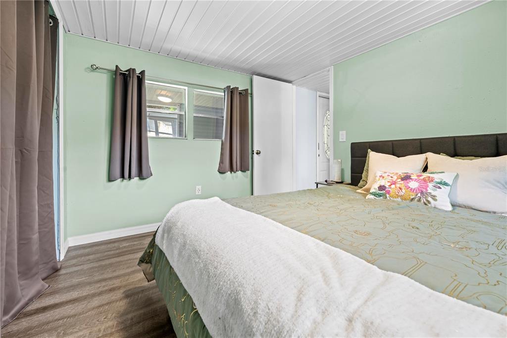 6380 Richard Drive Weeki Wachee, FL 34607 - Photo 32 of 59 a bedroom with a bed and wooden floor