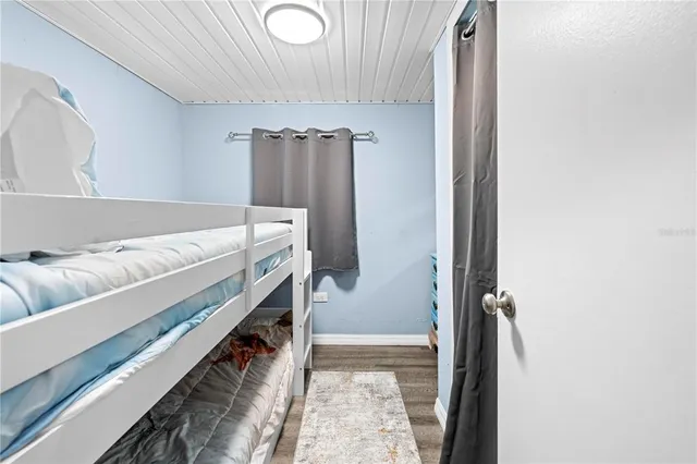 a view of a room with wooden floor and a sink