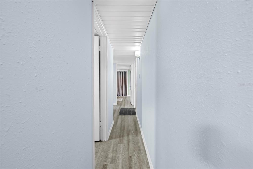 6380 Richard Drive Weeki Wachee, FL 34607 - Photo 38 of 59 a view of a hallway with wooden floor